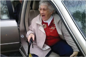 WOMAN WITH CANE SITTING IN CAR