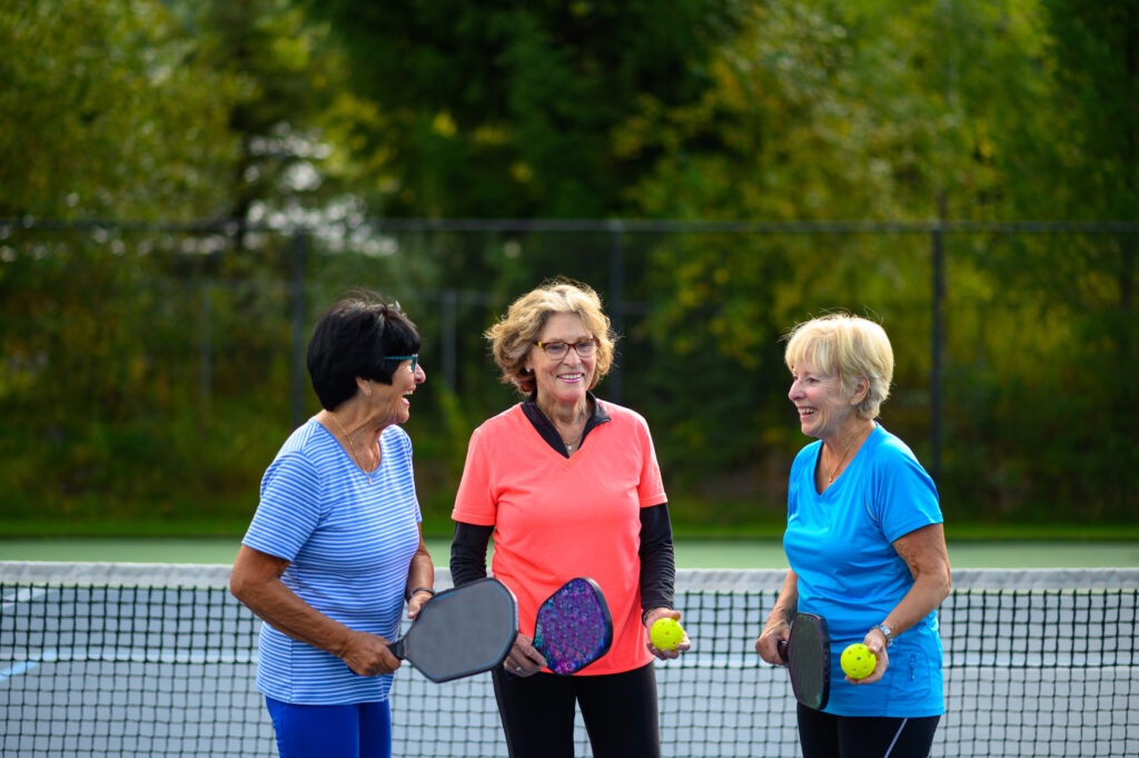 Senior women at a tennis court.